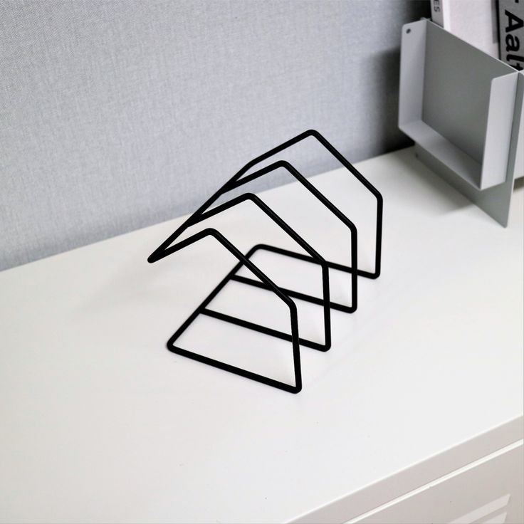 Contemporary geometric metal bookend with clean lines, ideal for minimalist decor and book storage.