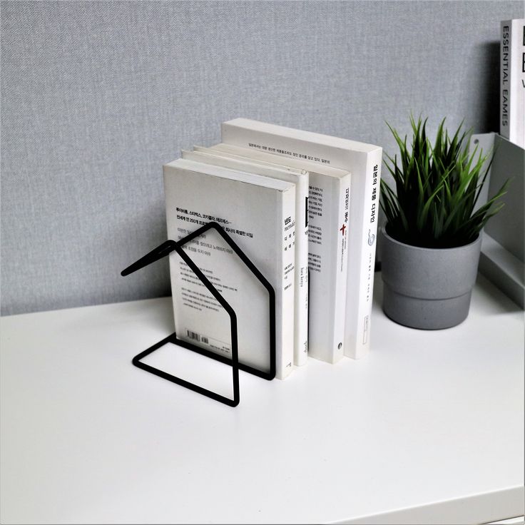 Geometric minimalist metal bookend with sleek lines, ideal for modern or industrial-style interiors.
